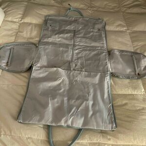 Travel or baby duffel bag. So fine with pockets, zippers, opens to place garment